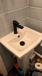 a sink with a black faucet